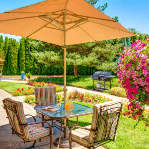 outside table with chairs and an umbrella for shade