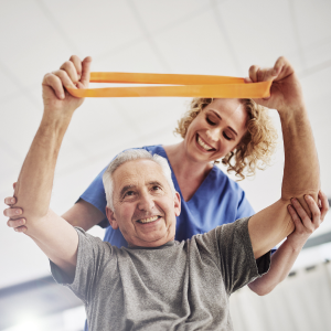 elderly person using a stretchy band to increase strength