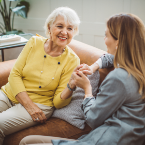 elderly person talking with someone and smiling