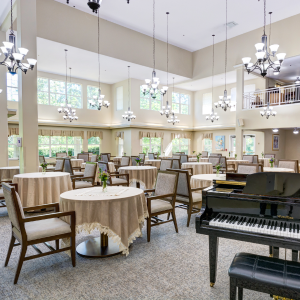 dining room with tables, chairs and a piano