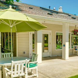 outside patio with table and chairs with an umbrella for shade