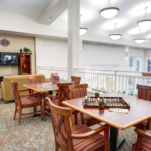 A cozy dining room filled with smiling seniors enjoying a delicious meal together at our vibrant senior living community.