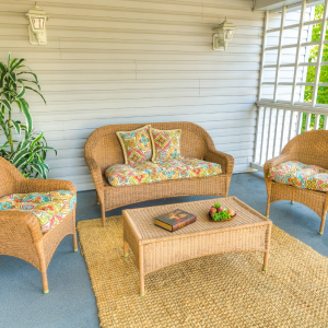 outdoor porch with lounging chairs and a table