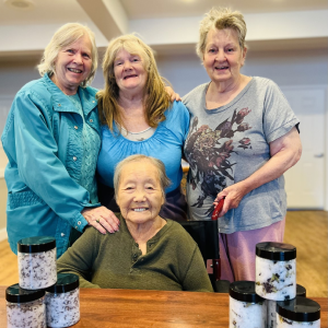 four women gathered around smiling