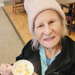 elderly woman holding a tea cup