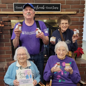 group of 4 elderly residents holding spices