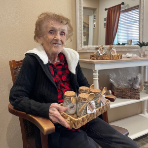 lady holding a basket filled with jars of lavender scrub