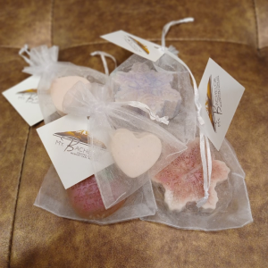 Neatly arranged soap bags, each with a tag attached.