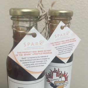 Two bottles of barbecue Sauce, a flavorful condiment with a vibrant spark, ready to enhance your culinary creations.