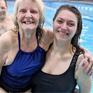 two women at a swimming class smiling