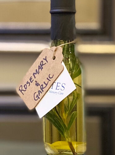 A bottle of aromatic rosemary and garlic oil, perfect for adding flavor to your favorite dishes.