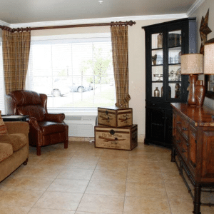 inside lounging area with couch, chair and dresser
