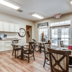tables and chairs with kitchen cabinets