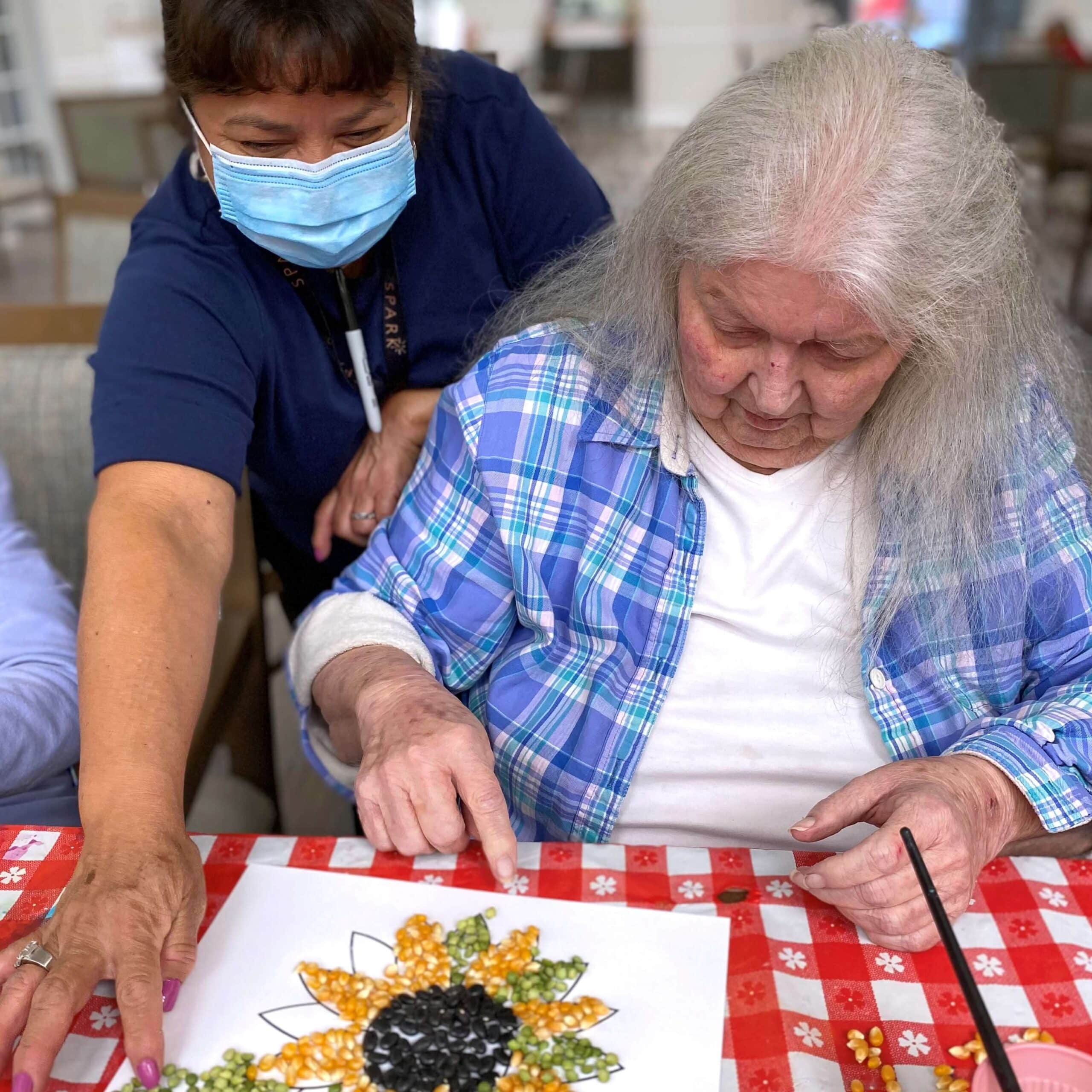 Elderly woman making a cogwheel craft