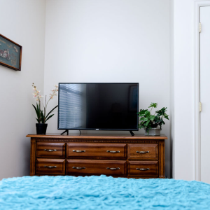 bedroom with television on top of dresser