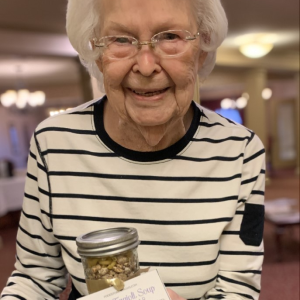lady holding pasta fagioli soup in a jar