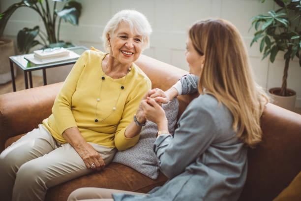 Senior woman talking with daughter Senior woman talking with her daughter at home. social senior stock pictures, royalty-free photos & images