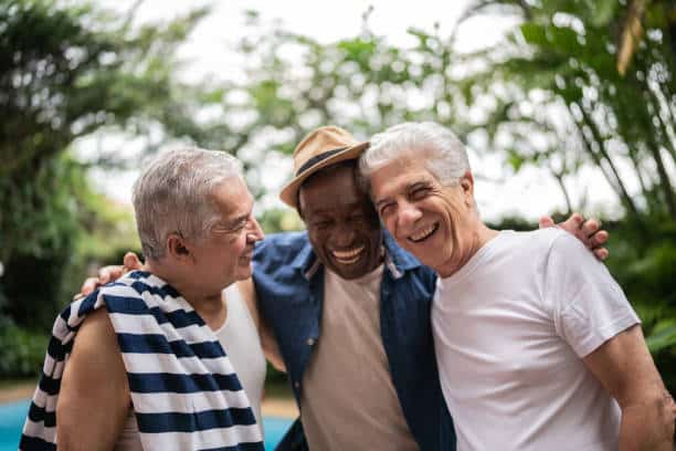 Senior men embracing on a pool party Senior men embracing on a pool party social senior stock pictures, royalty-free photos & images