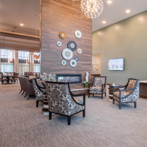 Take a look at this image: the lobby at the senior living community. It's a cozy space where residents can relax and socialize.
