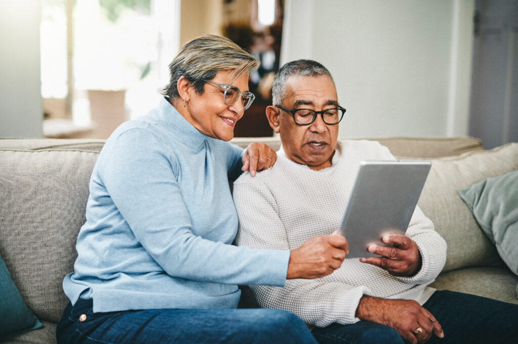 Two elderly people researching on an iPad
