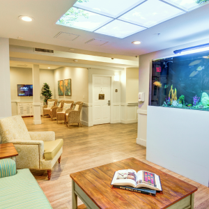 A living room with a fish tank and coffee table.