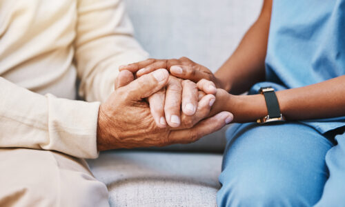 Caregiver, hands and senior patient in empathy, safety and support of help, trust and healthcare consulting. Nursing home, counseling and gratitude for medical caregiver, client and hope in consultation.
