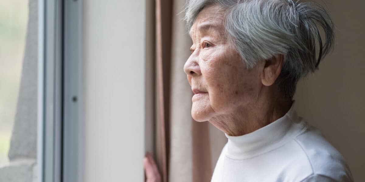 Senior woman looking outside.