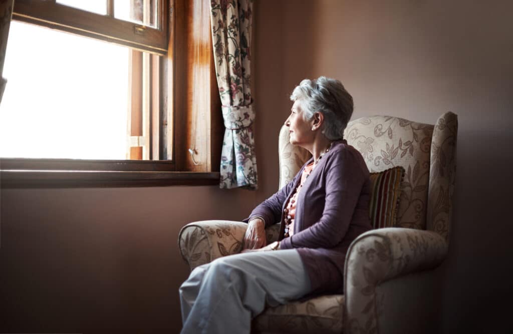 Shot of a senior woman sitting alone in her living room.