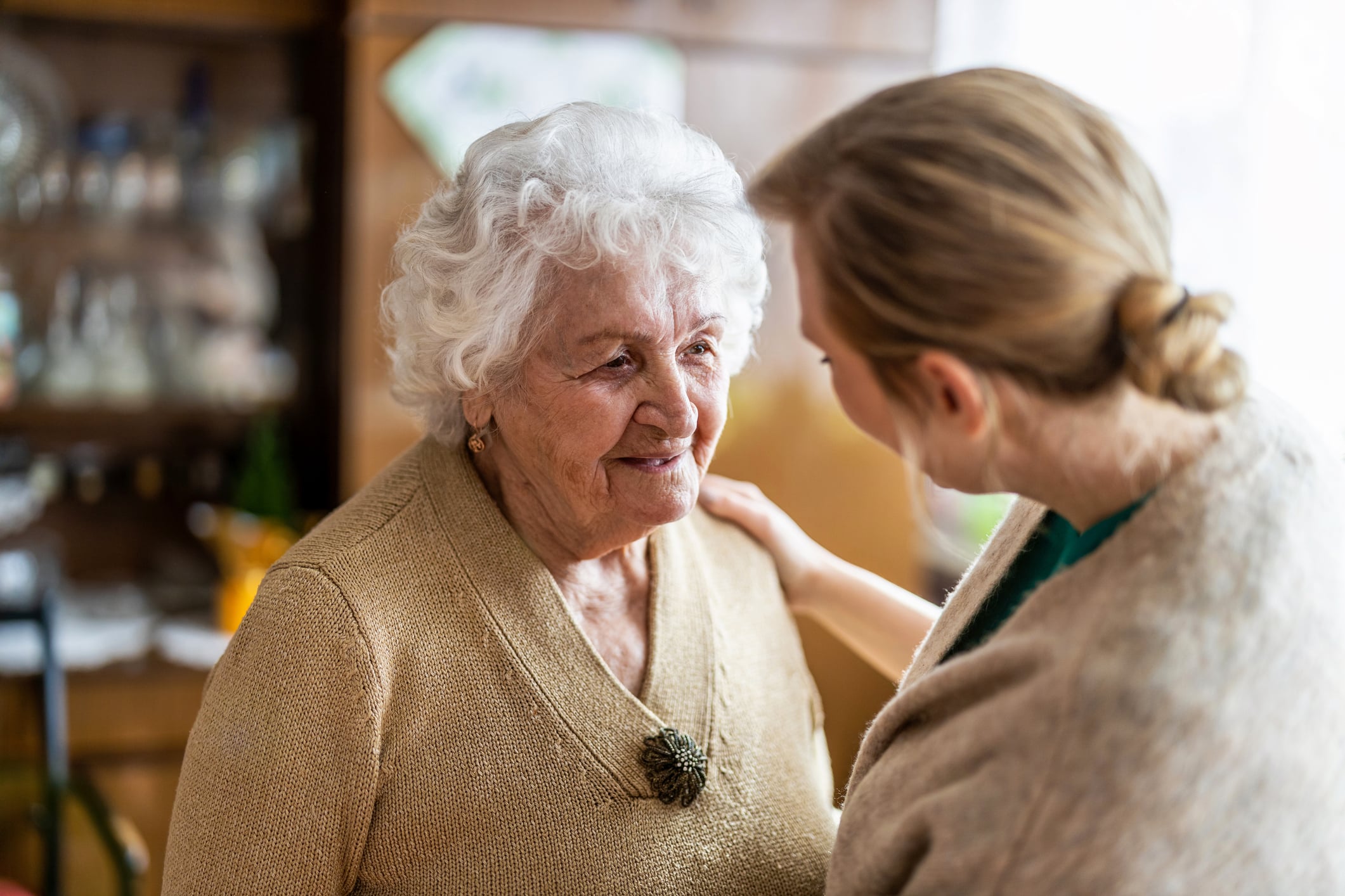 Health visitor talking to a senior woman during home visit