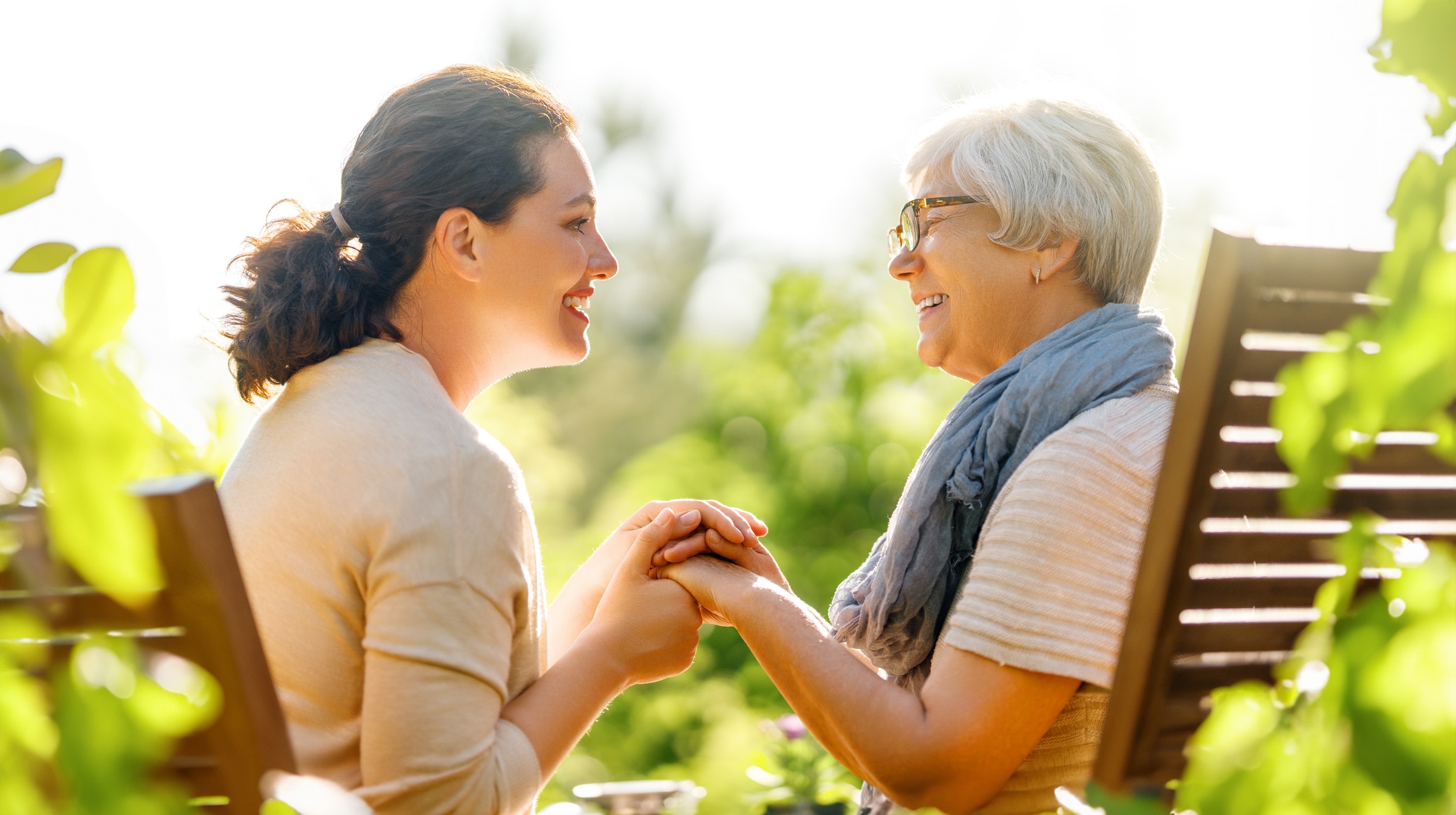 Happy young woman and her mother relaxing in summer morning.