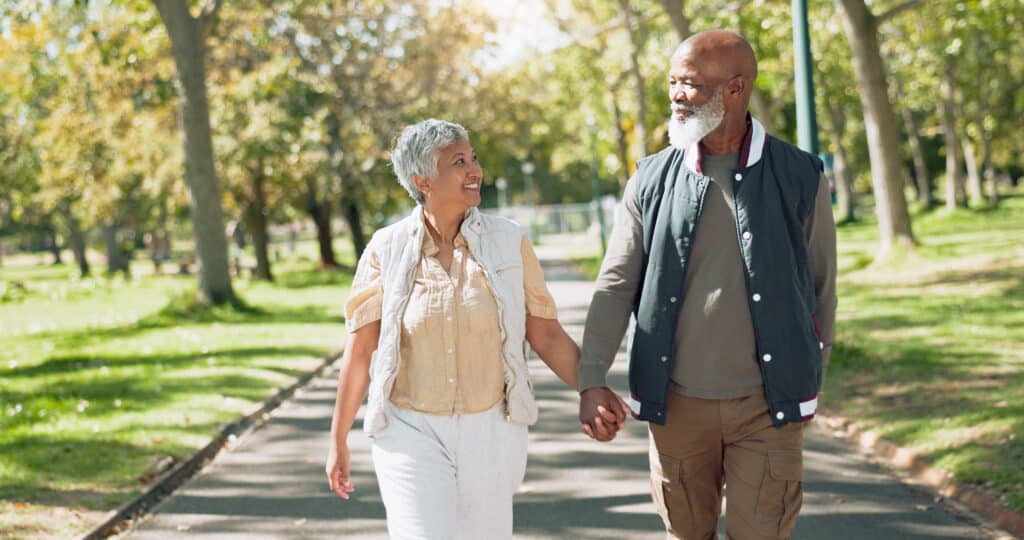 Smiling female home caregiver supporting senior woman in her house